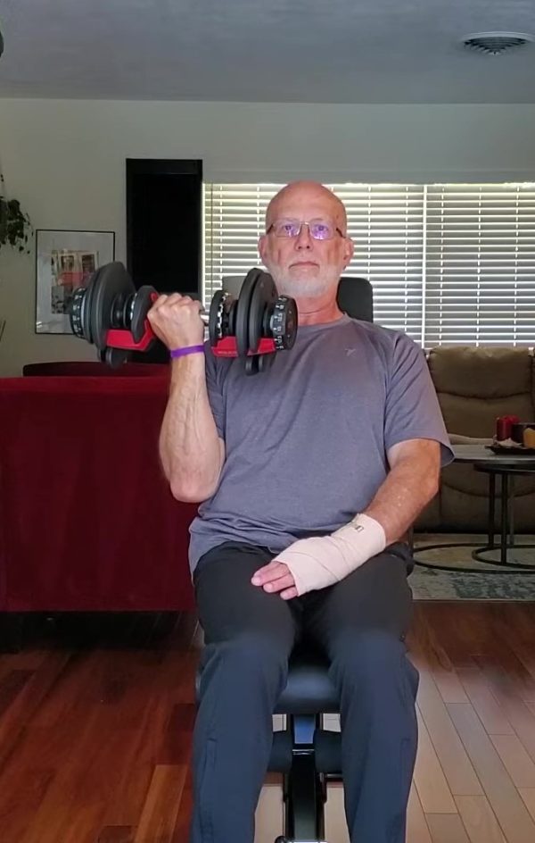 Fit over 50 Dave Durell from Strength After 50 performs a one arm dumbbell curl while working around an injury.