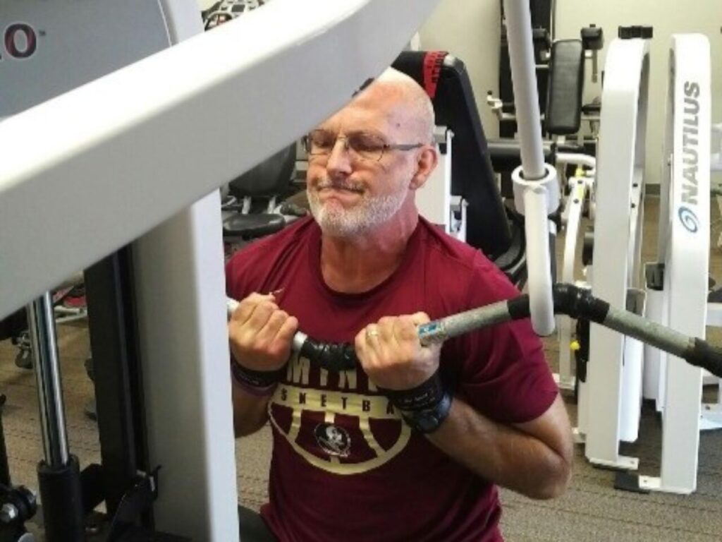 Man over 60 performing a pulldown exercise - how to regain muscle mass over 60
