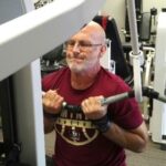 Man over 60 performing a pulldown exercise - how to regain muscle mass over 60
