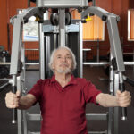 Senior man performing weight training for seniors
