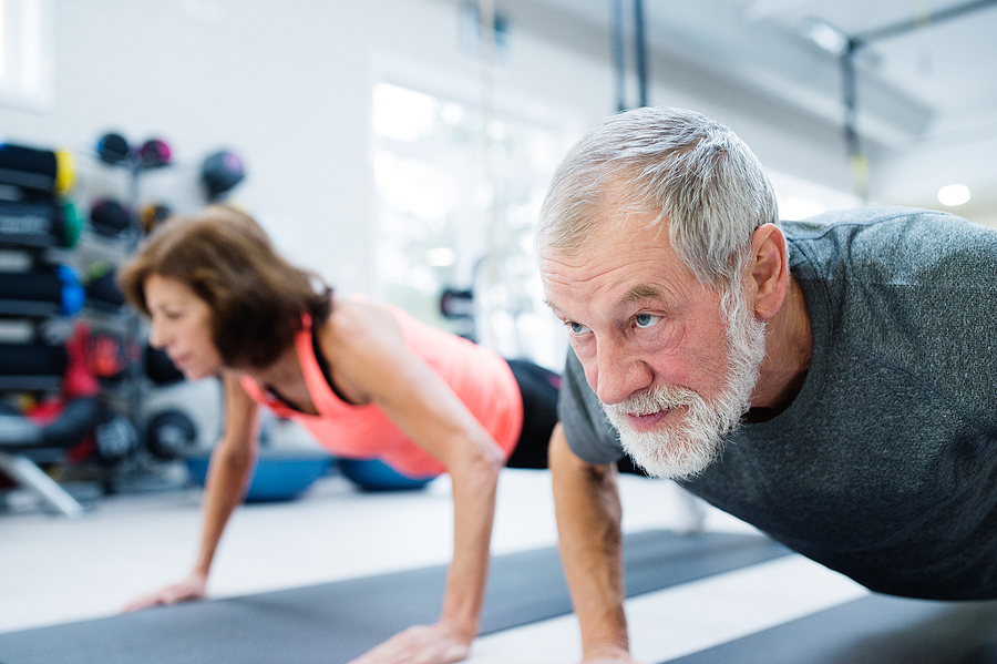 Couple doing pushups during strength training for seniors workout