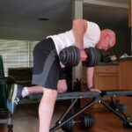 how many days a week should a 60 year old lift weights? Older man doing 1 arm dunbbell row exercise