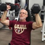 build more muscle after 50 - seated dumbbell shoulder press